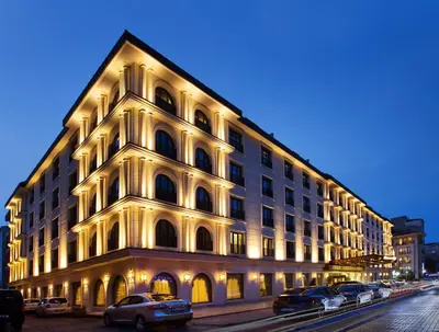 a large white building with cars parked in front of it at Ottoman's Life Hotel Deluxe in Istanbul