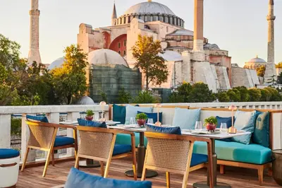 a patio with tables and chairs with a view of a mosque at Four Seasons Hotel Istanbul at Sultanahmet in Istanbul
