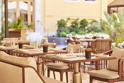an empty restaurant with wooden tables and chairs at Four Seasons Hotel Istanbul at Sultanahmet in Istanbul