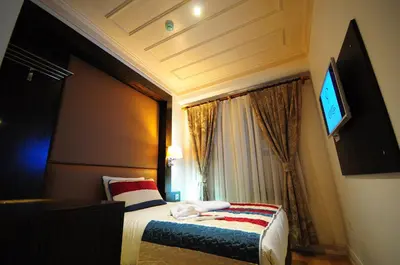 a hotel room with a bed and a television at Ottopera Hotel in Istanbul