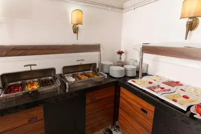 a kitchen with several trays of food on a counter at Premist Hotels Sultanahmet in Istanbul