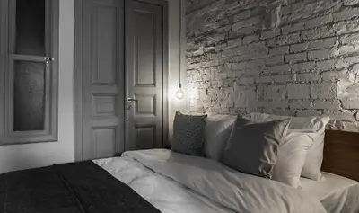 a bedroom with a brick wall and a bed at HAUS Galata in Istanbul