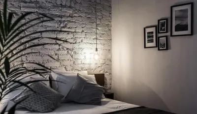 a bedroom with a bed with a brick wall at HAUS Galata in Istanbul