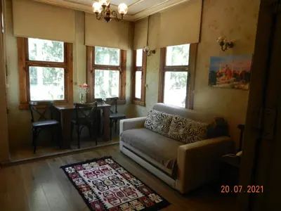 a living room with a couch and a table and windows at Royal Suites Sultanahmet in Istanbul