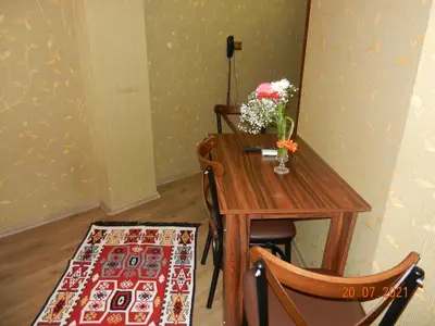 a table and two chairs with a vase of flowers on it at Royal Suites Sultanahmet in Istanbul