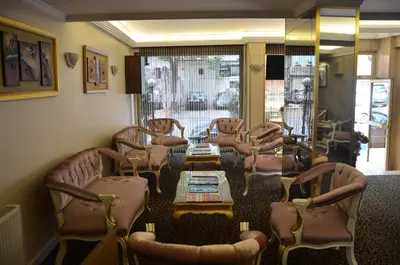 a waiting room with chairs and tables and a window at Mekke Hotel Istanbul in Istanbul