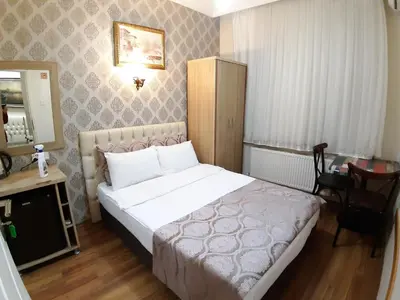 a bedroom with a bed and a table and a mirror at Burak Apart in Istanbul