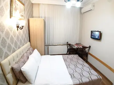 a small room with a bed and a table at Burak Apart in Istanbul