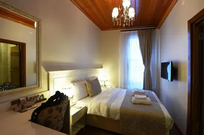 a bedroom with a bed with a mirror and a window at Elyka Hotel in Istanbul