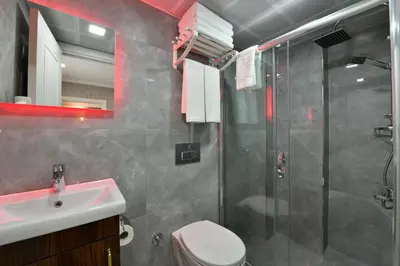 a bathroom with a shower and a toilet and a sink at Sea Moon Hotel in Istanbul