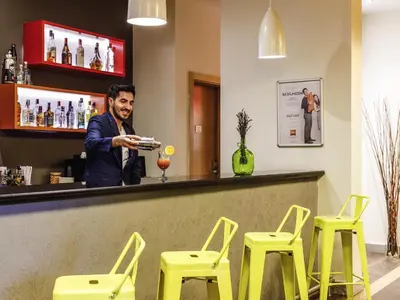 a man preparing a drink at a bar at Ibis Istanbul Esenyurt in Istanbul