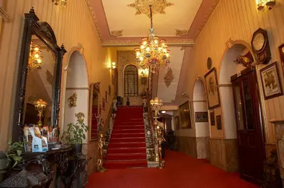 a hallway with stairs and a chandelier at Grand Hotel de Londres in Istanbul