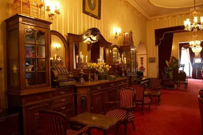 a room with a large mirror and some chairs at Grand Hotel de Londres in Istanbul