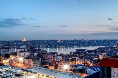 a city at night with a river and buildings at Grand Hotel de Londres in Istanbul