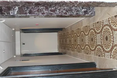 an empty kitchen with a wall with tiles on it at Kadikoy Otel in Istanbul