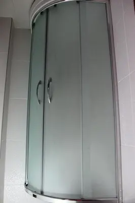 a glass cabinet with two handles in a bathroom at Kadikoy Otel in Istanbul