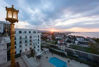a street light on a building with the sunset in the background at Wellborn Luxury Hotel in Kocaeli