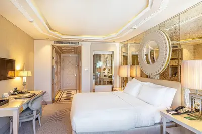 a bedroom with a bed and a desk and a computer at Wyndham Grand Istanbul Kalamış Marina Hotel in Istanbul