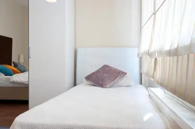 a small bedroom with a bed and a window at Aslan Apartments in Istanbul