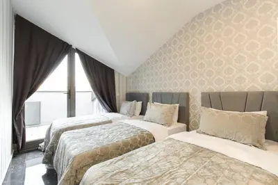 a bedroom with two beds and a window at The Loft House Taksim in Istanbul