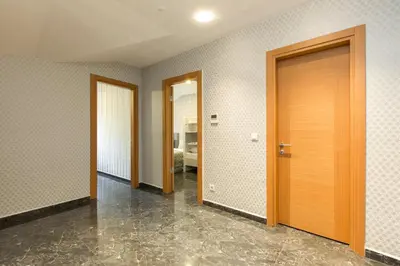 an empty room with three doors and a hallway at The Loft House Taksim in Istanbul