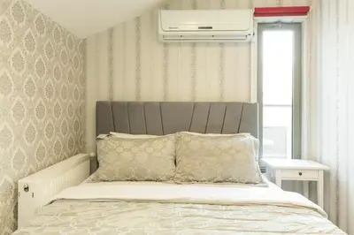 a bed with a gray headboard in a bedroom at The Loft House Taksim in Istanbul