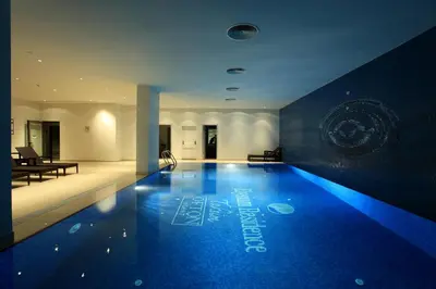 a swimming pool with blue lights in a building at The Loft House Taksim in Istanbul