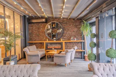 a living room with chairs and a fireplace at BEST GARDEN HOTEL in Istanbul