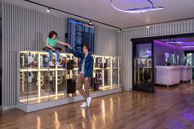 a man standing in front of a display case with a girl on it at YOTEL Istanbul Airport, City Entrance in Istanbul