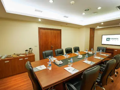 a conference room with a large wooden table and chairs at Feronya Hotel in Istanbul