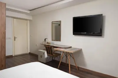 a hotel room with a desk and a television on the wall at Taksim Mood in Istanbul
