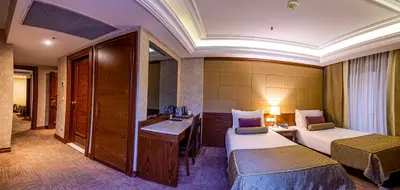 a hotel room with two beds and a desk at Eurostar Old City Hotel & Spa in Istanbul