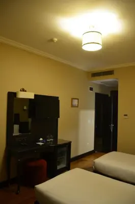a room with two beds and a desk and a lamp at Sultan Mehmed Hotel in Istanbul