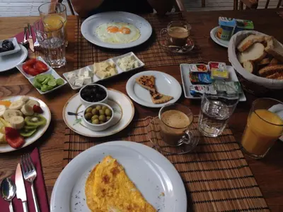 a wooden table with plates of food on it at Sultan Mehmed Hotel in Istanbul