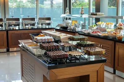a buffet line with cakes and other food on it at Miracle Istanbul Asia Airport Hotel & Spa in Istanbul