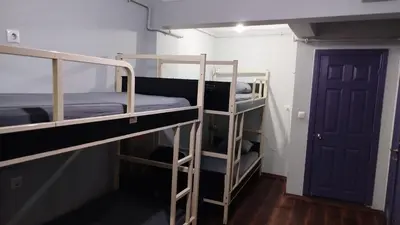 two bunk beds in a room with a door at ivy hostel cafe in Istanbul