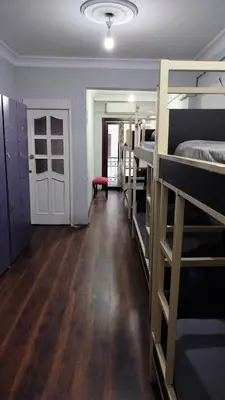a room with several bunk beds and a hallway at ivy hostel cafe in Istanbul