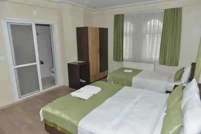 a hotel room with two beds and a bathroom at Teras Hotel Kağıthane in Istanbul