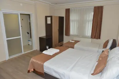 a hotel room with two beds and a window at Teras Hotel Kağıthane in Istanbul