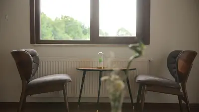 a table and two chairs and a vase with a vase at Orchid Hills - heated swimming pool in Sapanca