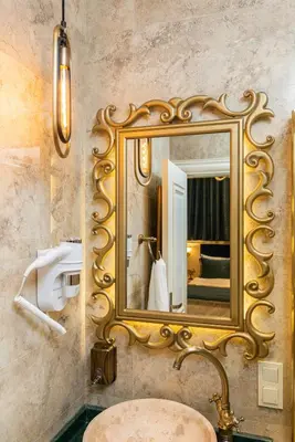 a bathroom with a gold mirror and a sink at Begonville 2 Mansion Oldcity in Istanbul