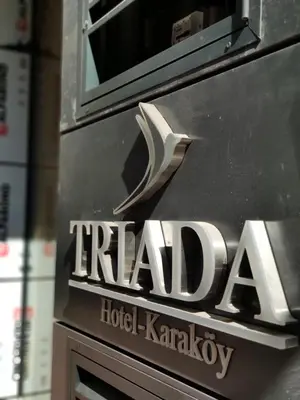 a sign for a hotel karachiachiachiquartered hotel karachiachi at Triada Hotel Karaköy in Istanbul