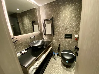 a bathroom with a sink and a toilet and a mirror at Triada Hotel Karaköy in Istanbul