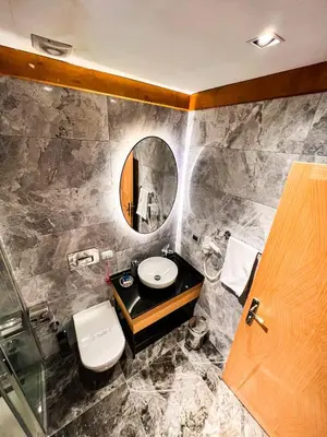 a bathroom with a toilet and a sink and a mirror at Triada Hotel Karaköy in Istanbul