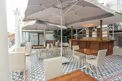 a patio with tables and chairs and an umbrella at The Loft Istanbul in Istanbul