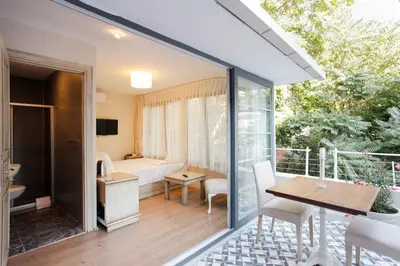 a room with a balcony with a table and a bedroom at The Loft Istanbul in Istanbul