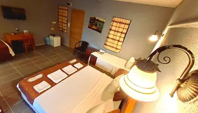 a room with two beds and a lamp at Elite Hotel City Center Corlu Bed and Breakfast in Corlu