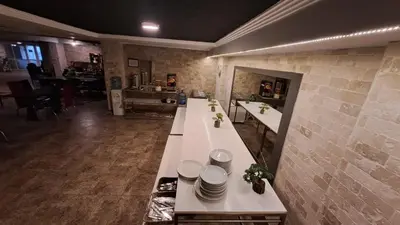 a kitchen with a long counter with plates on it at Elite Hotel City Center Corlu Bed and Breakfast in Corlu