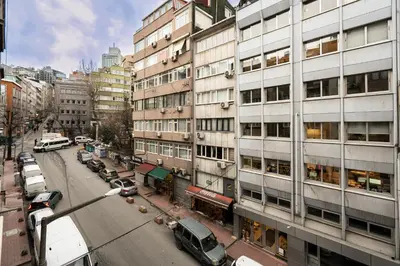 a city street with cars parked in front of buildings at Cihangir Palace Hotel in Istanbul