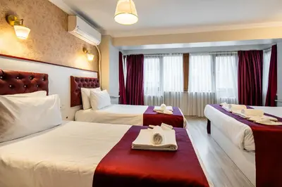 a hotel room with two beds with towels on them at Cihangir Palace Hotel in Istanbul